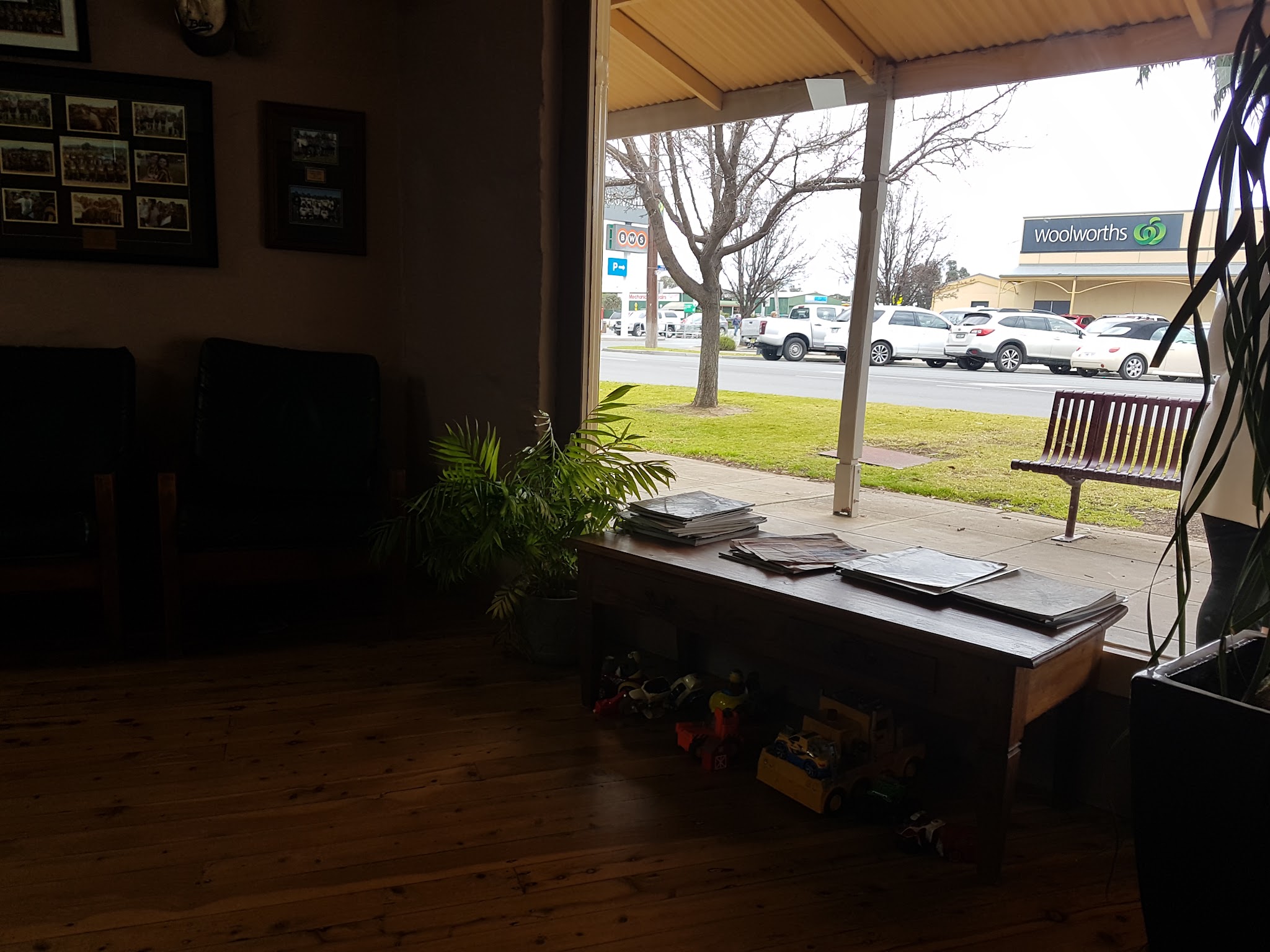 Looking out the big front window of the shop onto Punt Rd, with the waiting area and magazines inside